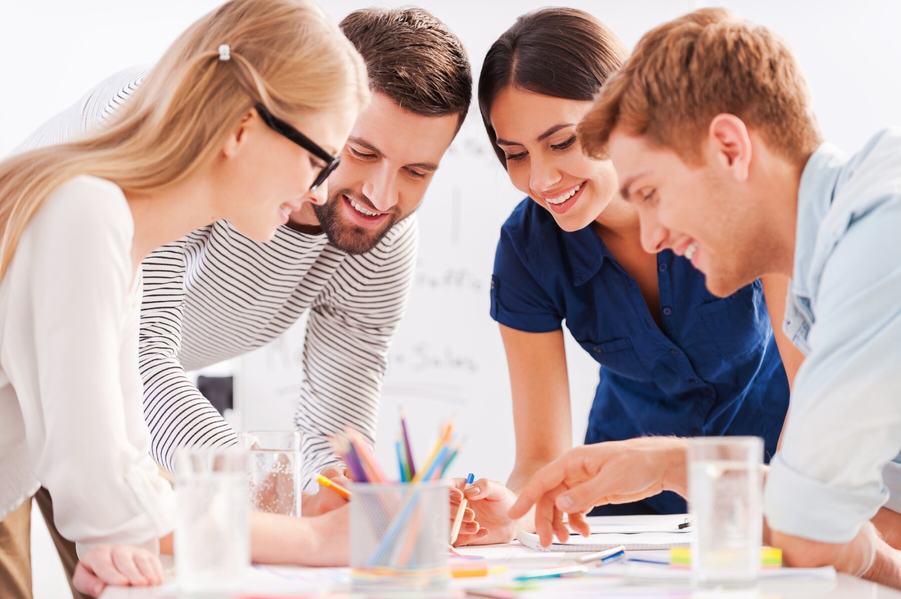 Colleagues write a story together during a creative teambuilding workshop